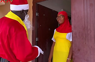 Nigeria Santa Claus exchanges gift with a college girl who just returned from boarding school to spend Christmas holidays