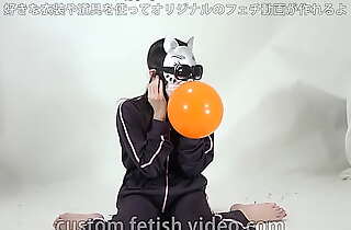 A girl inflates coupled with splits a balloon