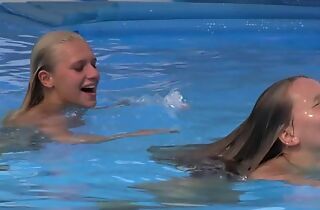 Two beautiful girls swimming with the addition of licking by the pool