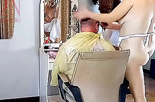 Nudist barbershop. Nude lady hairdresser in an apron. Security camera. The client is surprised. cam 12